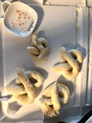 Sourdough pretzels knotted and salt added.