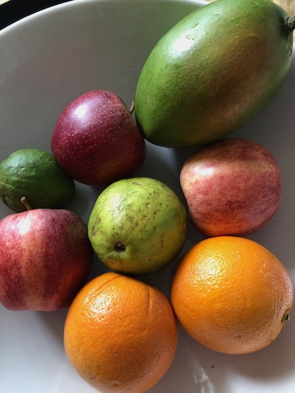 A bowl of fruits with the guava in the middle.