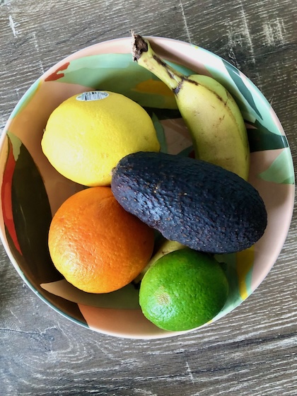 A fruit bowl of anti-inflammatory foods that are good to add to a grocery list.