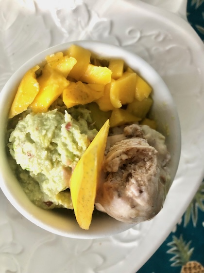 Bowl of homemade avocado ice cream with mango and chocolate.