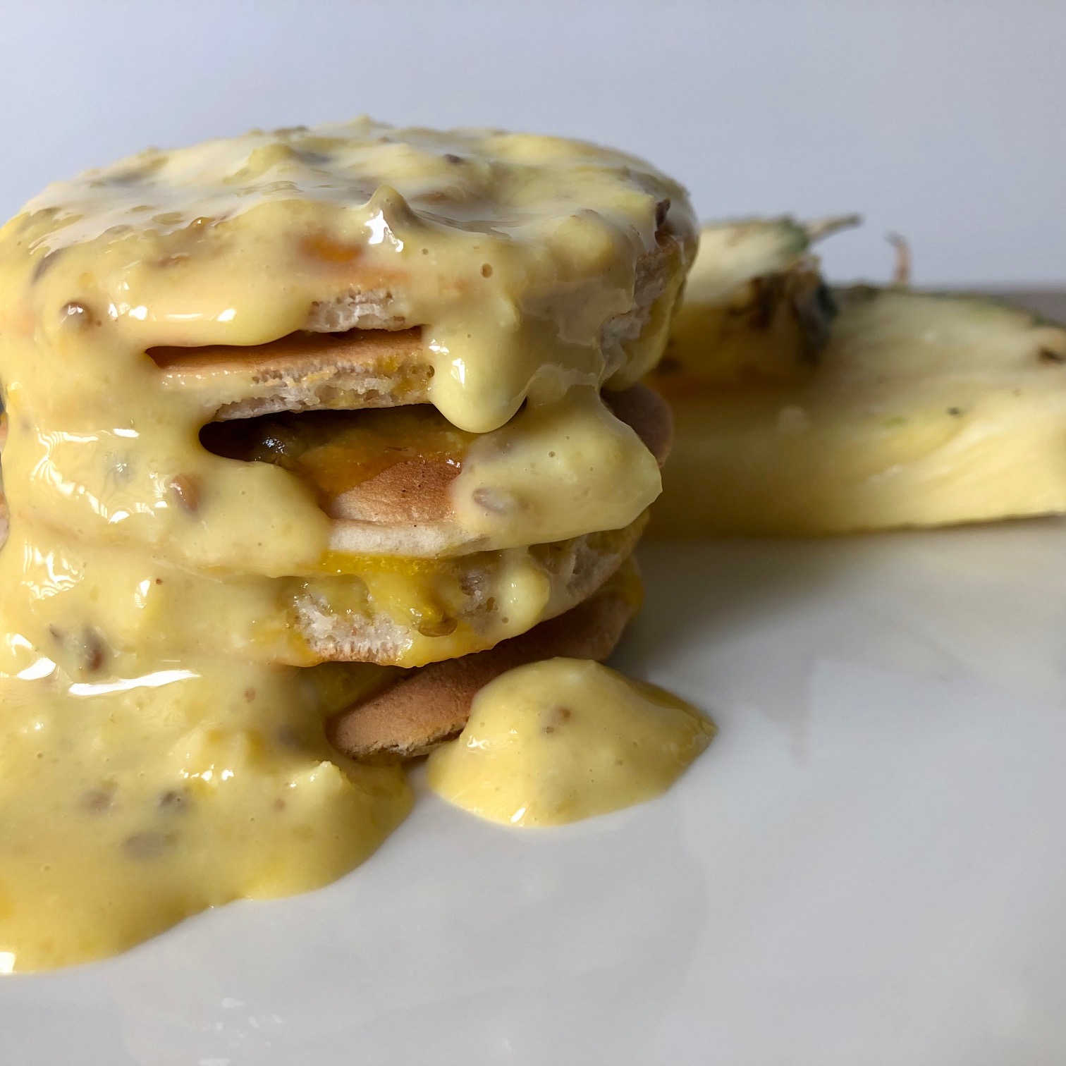 Homemade pineapple pancake stack that has a pineapple creme anglaise custard for the strong flavor.