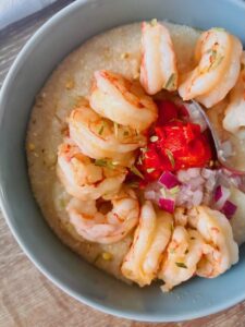 shrimp and grits with sweet peppers and onions.