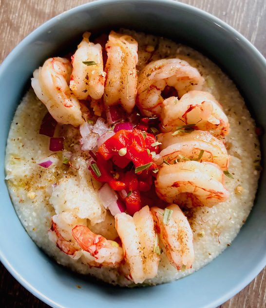 Old Bay and spices on shrimp and grits bowl.