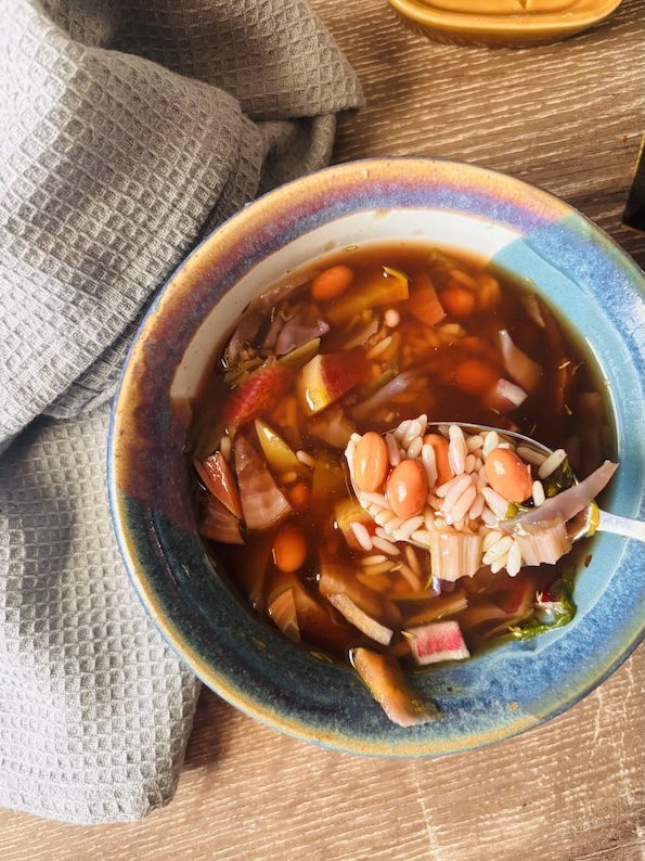 fall vegetable soup with fresh veggies, beans, and a umami base but no tomatoes.
