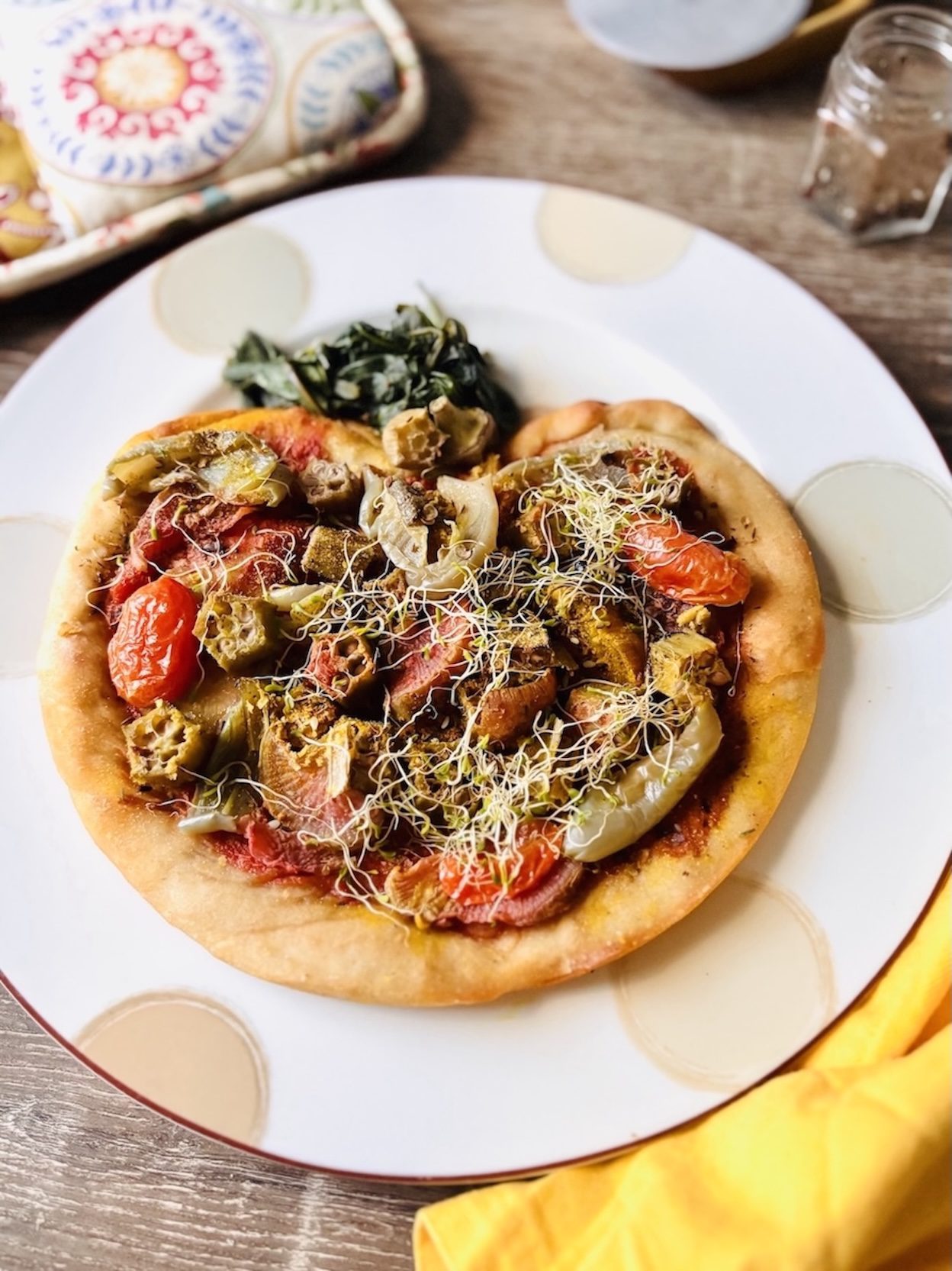 Vegetable pizza made from a home oven in the shape of a tomato.