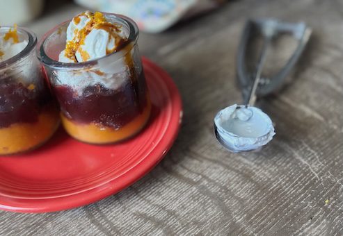 cranberry pumpkin trifle with healthy yogurt and orange zest topping.