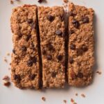 chocolate chip granola bar cut in a trio on a plate.
