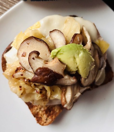 fermented cabbage on an open faced plant-based sandwich.