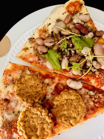 tofu pepperoni and plant-based food on pizza slices.