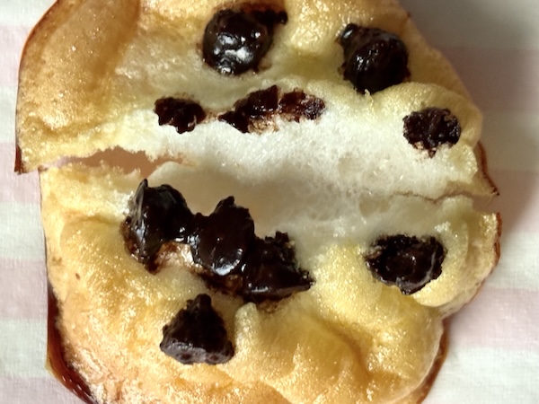 Double baked chocolate chip meringue cookie broken in half where you see the airy inside.