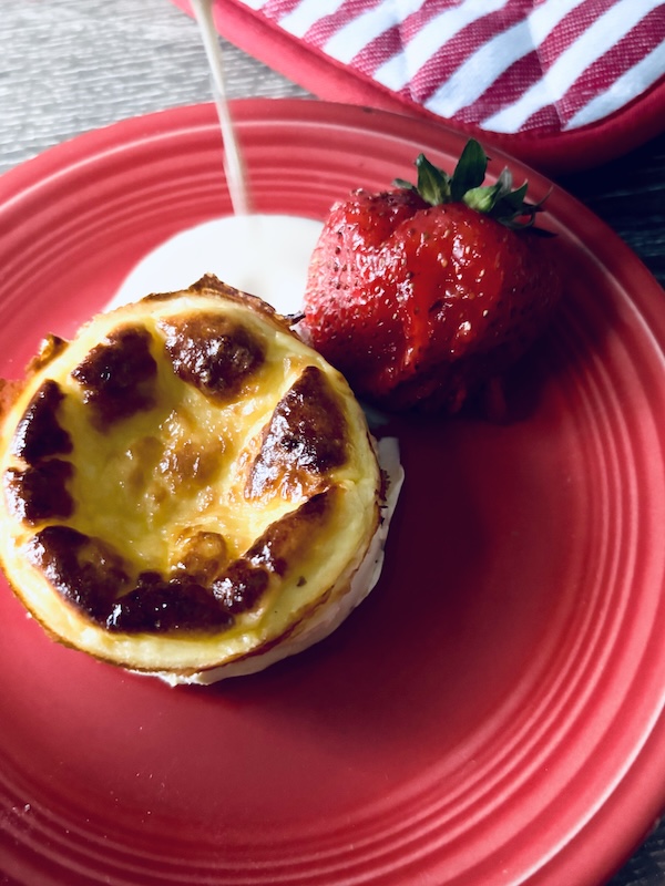 ricotta cheese cake with curd drizzle on a plate.